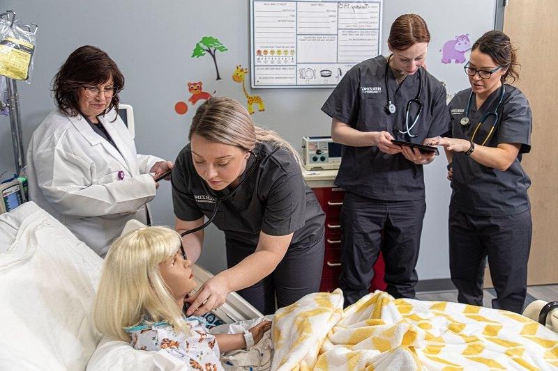 Nurse Practitioner Who Went from RN to MSN Standing with Medical Staff