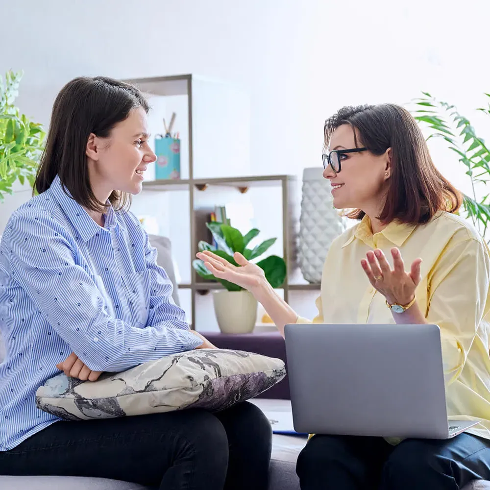 Psychologist with Laptop Speaking with Patient