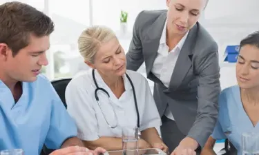 Manager with MBA in Healthcare Management in Discussion with Healthcare Staff