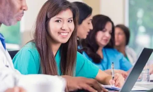 Practical Nurse at Laptop in School Taking On-Campus Nursing Classes