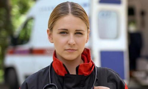 EMT in Birmingham with Certificate in Front of Ambulance 